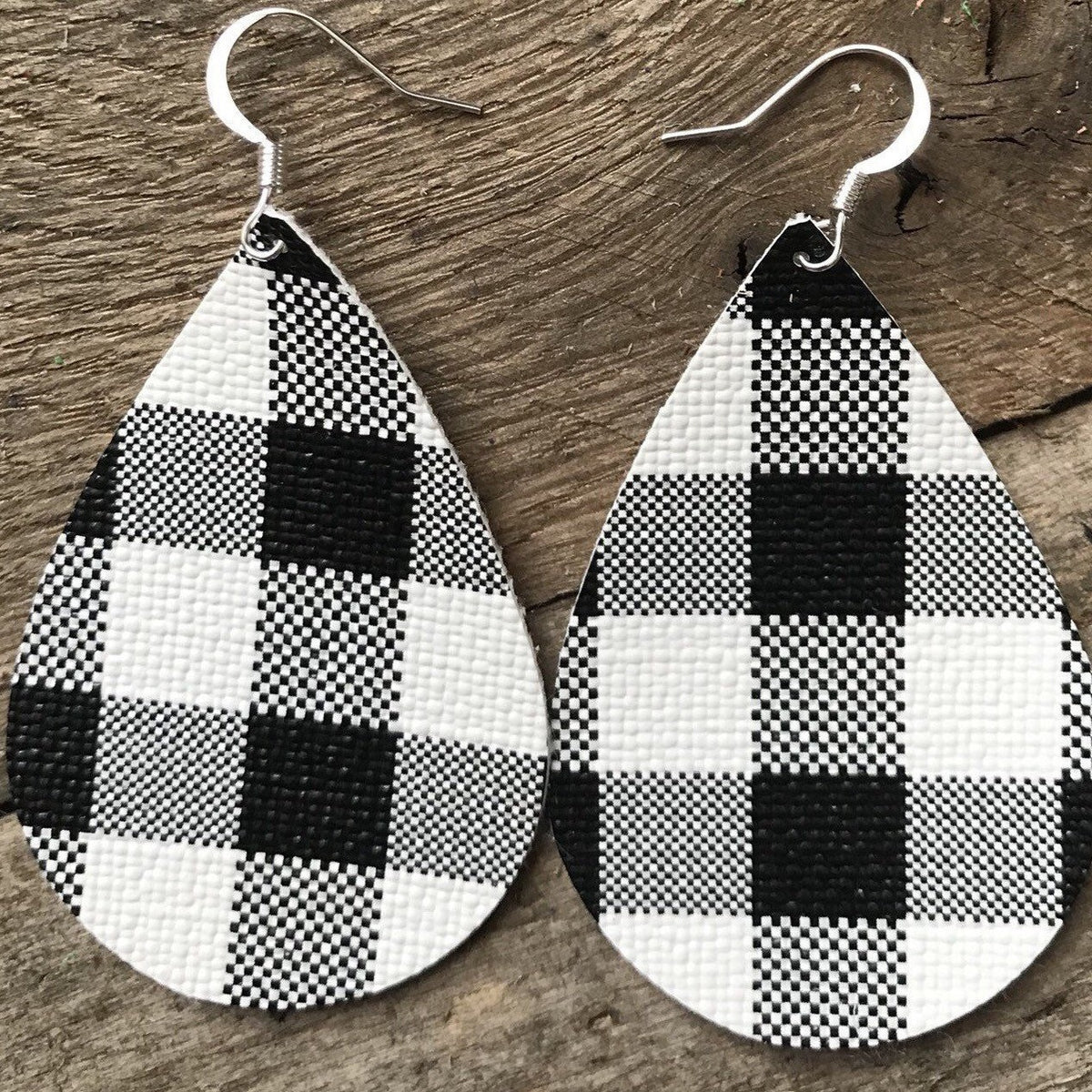 Bear earrings in buffalo check black and white  plaid with black bear in center of teardrop shaped wood slice earrings 2 inch