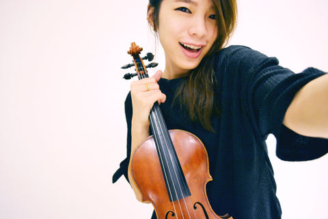 Asian woman holding a violin