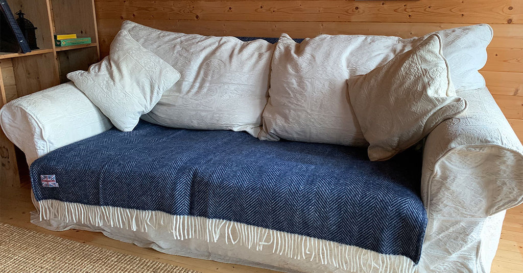 Navy Herringbone Wool Blanket Draped over the back of the sofa
