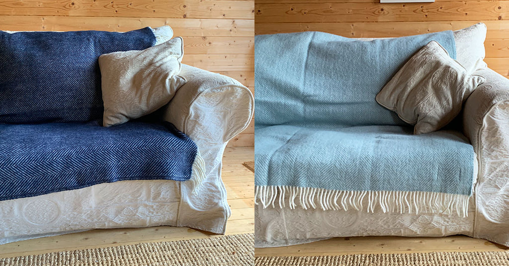 Duck Egg and Navy Herringbone Wool Blanket Covering the seat cushions on an old white sofa