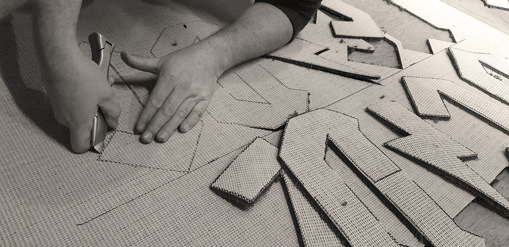 Hand cutting of a carpet at Fat Bob'b Emporium