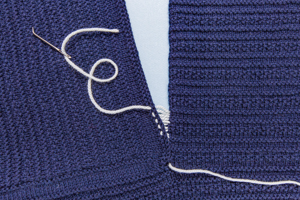 side to top seaming of hand knit wool sweater using mattress stitch technique