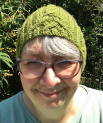 Woman wearing green cabled hat - River Lea Rambles Hat