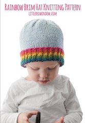 Child wearing a hat with a rainbow brim