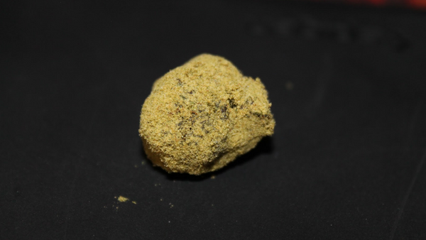 one lonely moon rock nug black background