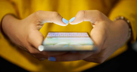 Closeup of woman's hands holding a smart phone.