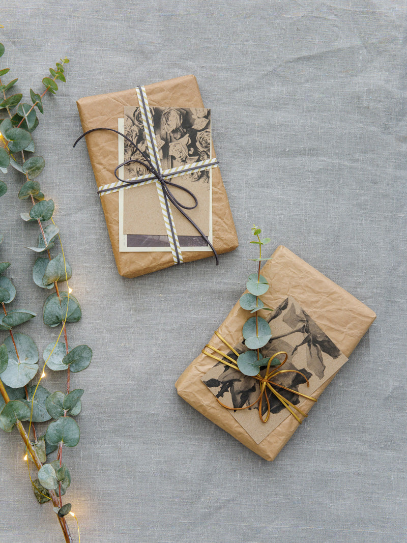 Brown paper parcels with vintage postcards