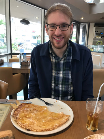 Adam eating a large Dutch pancake in Rotterdam, Netherlands - taken by Amy Reader Artist