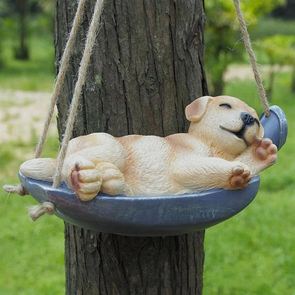 Image of a Labrador Sleeping Statue hanging on a tree branch made of resin