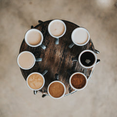 8 cups of coffee in a circle all different shades representing the diversity of colour of people on this planet.  