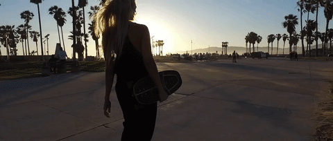 blonde girl wearing black forrest and bob tank top on venice beach in los angeles california
