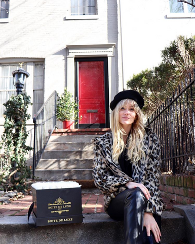 Meredith Holland posing with Boite de Luxe Grand Square flower arrangement