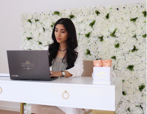 Mandana, Founder of Boite de Luxe working in her home office featuring the Flower Wall and Petite Square collections.