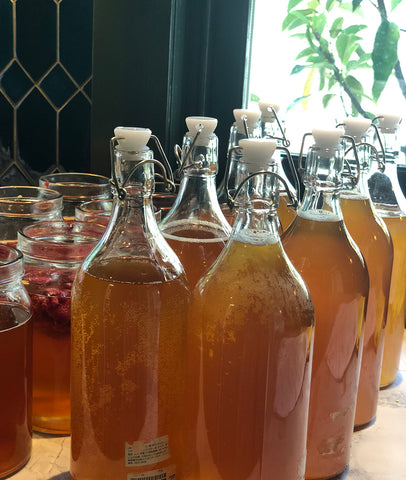 Bottled plain Kombucha and jars with flavour ready to sit for two days