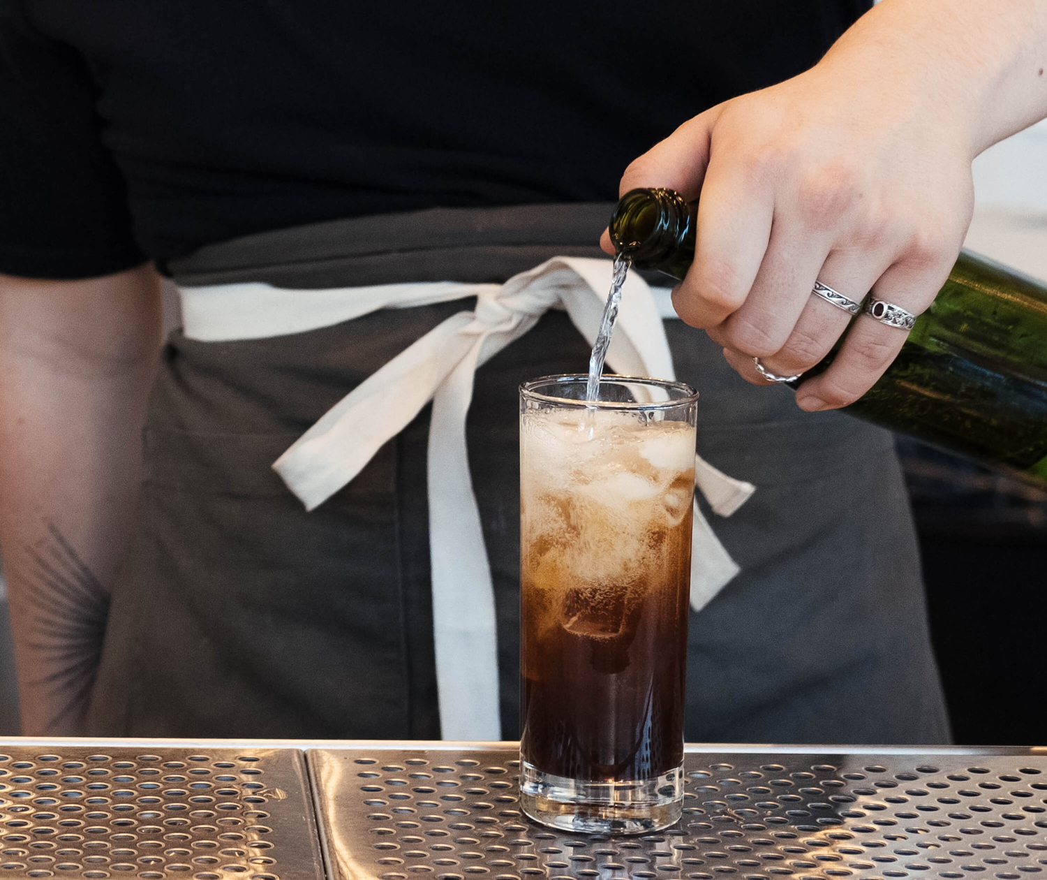 Collins glass with ice and add 1 ounce of the dissolved coffee.