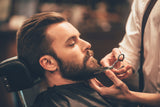 man getting his beard trimmed