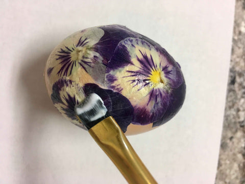 coat pressed flowers and egg with glue