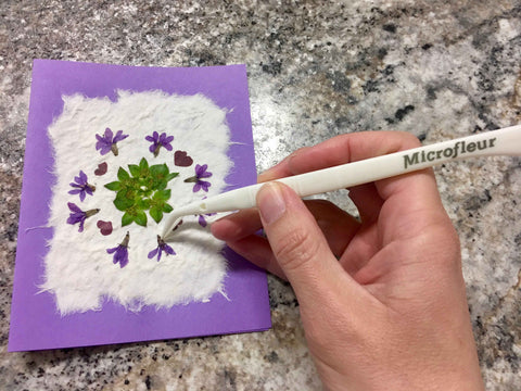 glue and place flowers on mulberry paper
