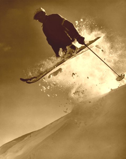 Jumping a cornice on old wood skis.