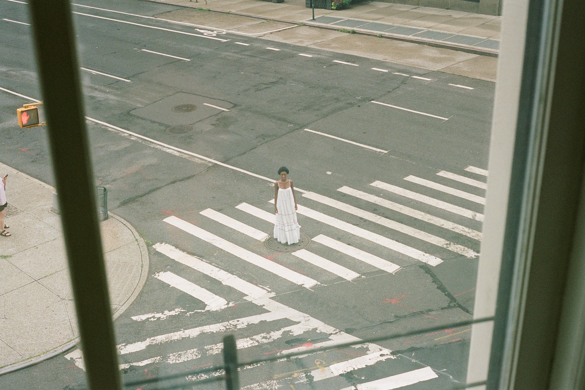 Woman in white dress on standing in the street