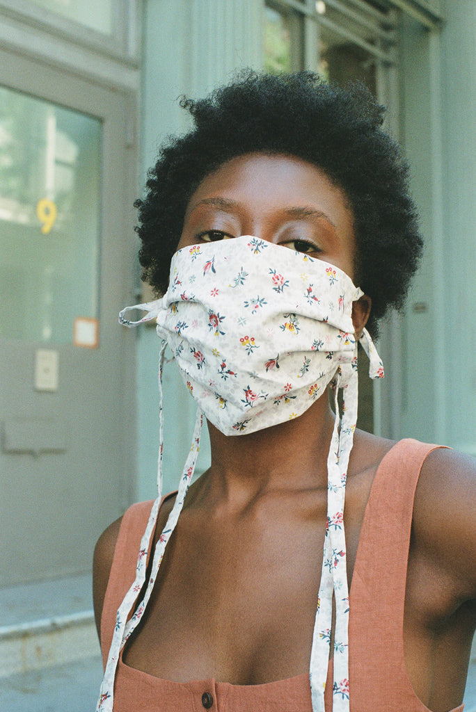 woman in white floral face mask