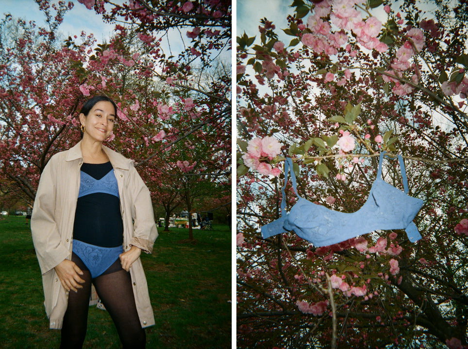 Woman wearing a blue underwear and bra over tights with a coat, and a photo of a blue bra hung on a tree.