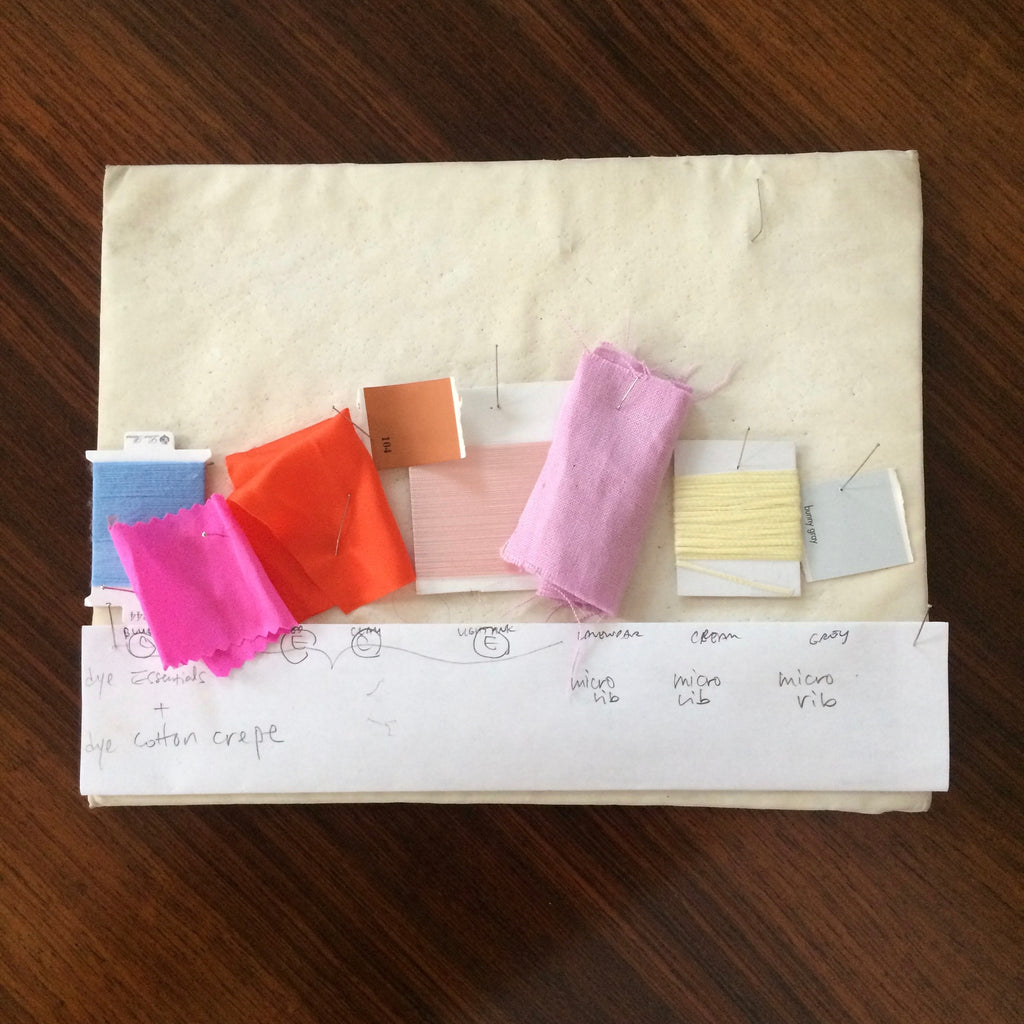 Fabric swatches laid across a board as a color palette.