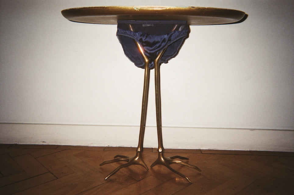 Blue underwear on a gold table.