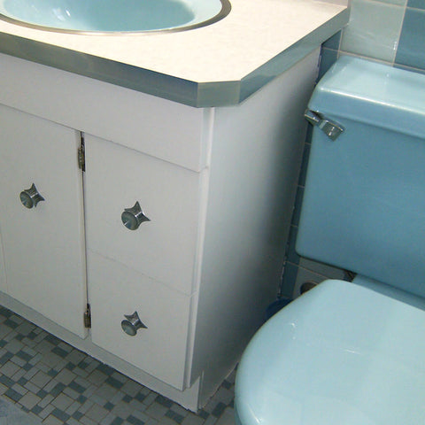 A retro renovation, save the blue bathroom. Blue toilet, starburst hardware and cabinet