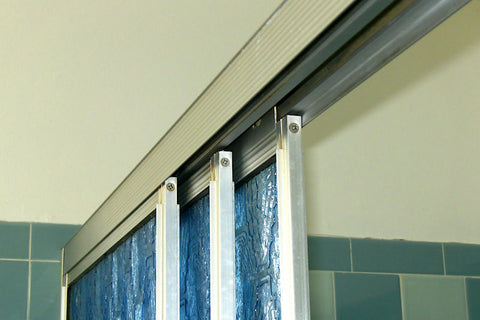 A retro renovation, save the blue bathroom. Sliding glass shower doors.