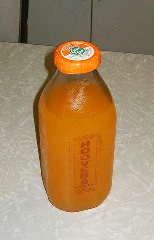 Green Spot Orange drink in a dairy bottle