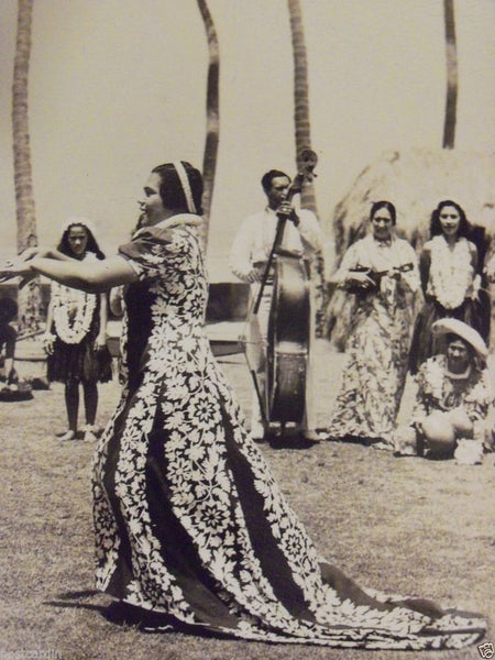Women wearing traditional holoku dress