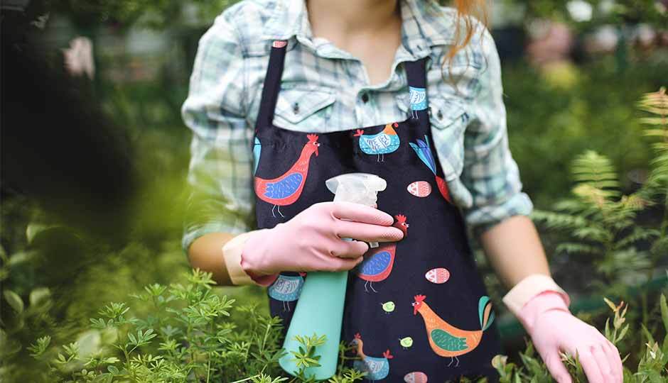 woman in garden wearing chicken print apron