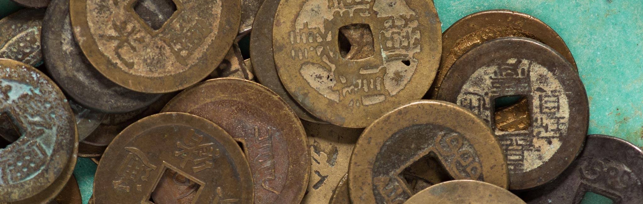Closeup image of Chinese coins on pottery
