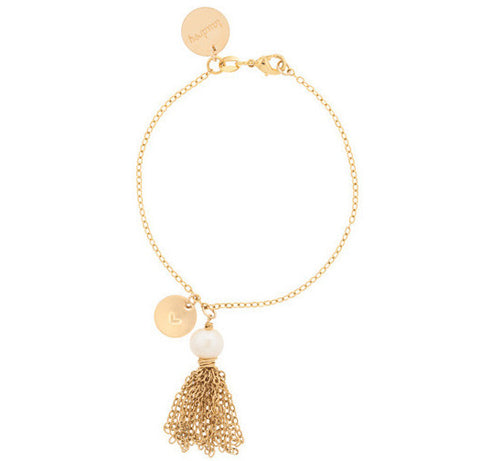 taudrey tassles on a gold leash bracelet with charm and gold tassel