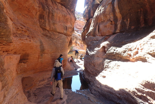 Group hiking in the canyons of Moab, Utah
