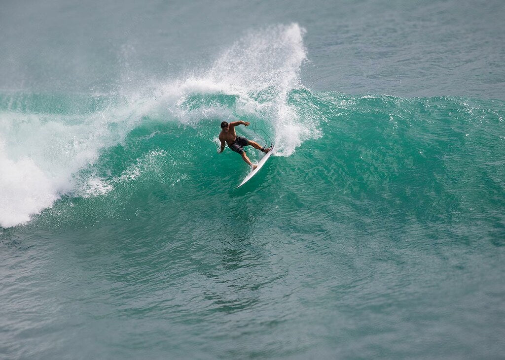 Professional surfer riding the waves in Bali