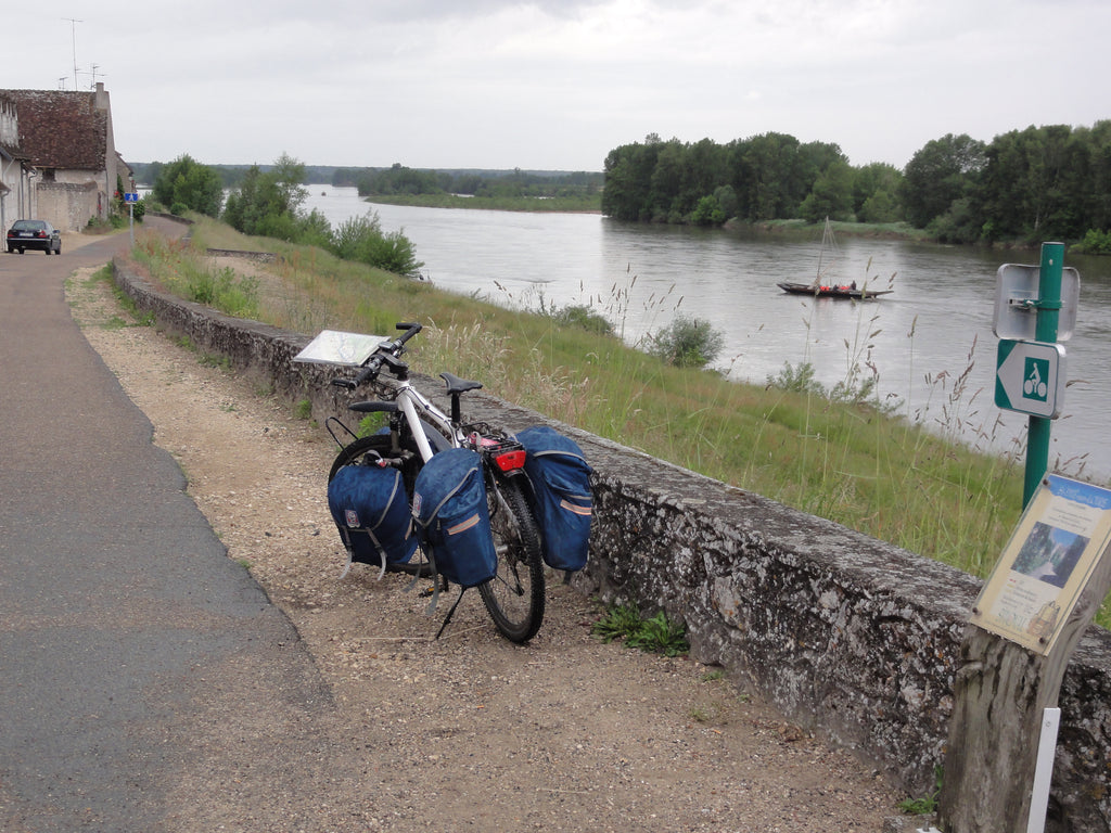 Bicycle with baggage on the side of the road, prepared for travel