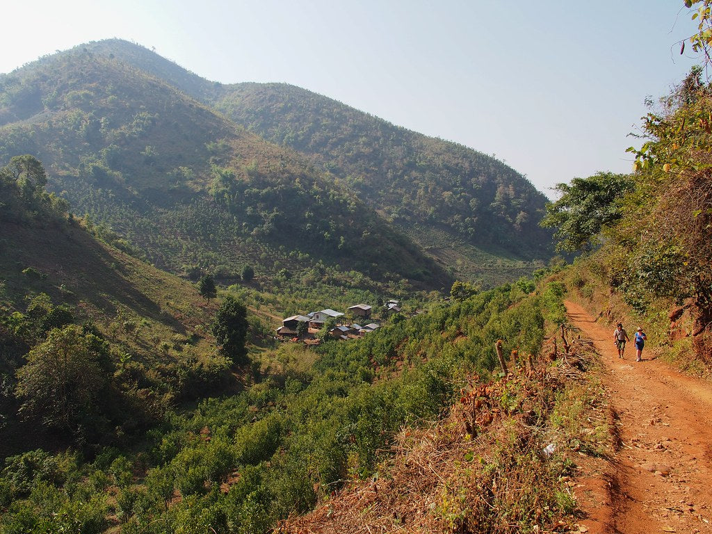 Tourists trekking to a mountain village in Myanmar
