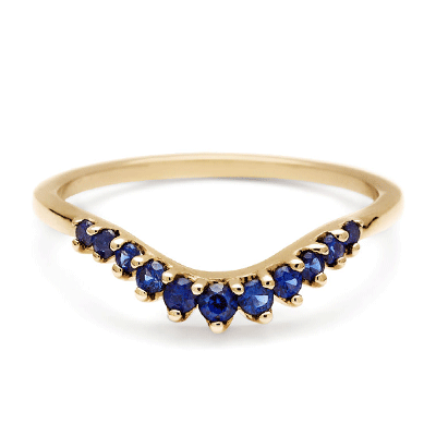 A yellow gold tiara curve wedding band with 11 round sapphires.