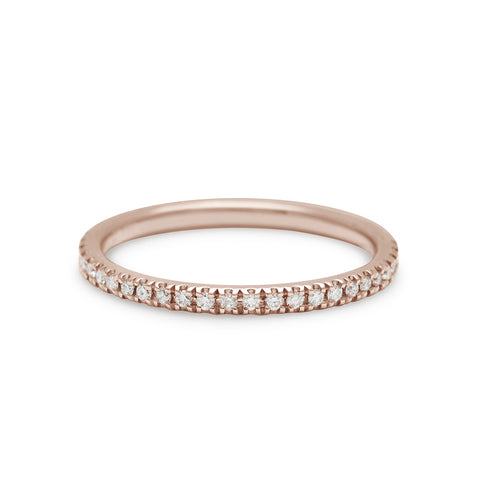 A straight band with white diamond pave set in eternity around the band set in rose gold. 2