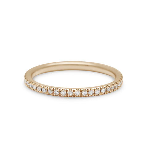 A straight band with white diamond pave 3/4 of the way around the band set in yellow gold.