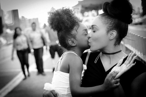 Illumine Mother and daughter kissing