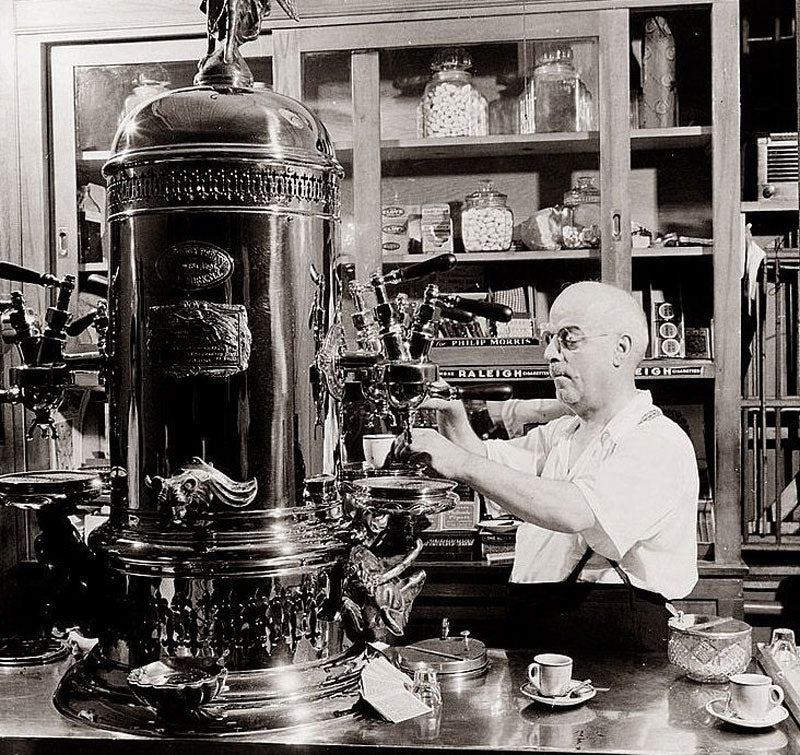 An old espresso machine, they originally had a cylindrical and vertical typology, which later would evolve to a bar-style dispenser.