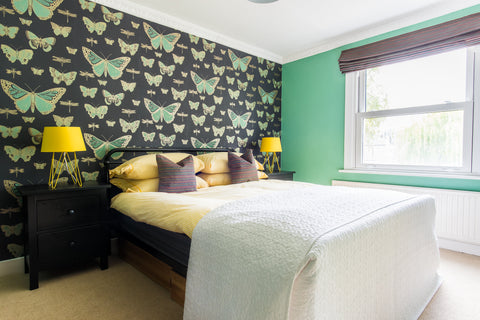 spare room. arsenic by farrow and ball on the walls. cole and son butterfly wallpaper pops of yellow fleur ward interior design