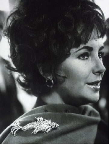 Elizabeth Taylor wearing a brooch on her scarf