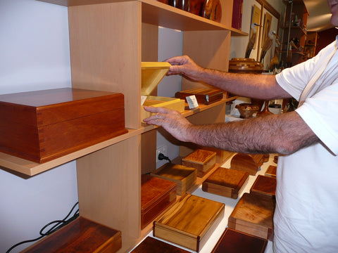 Man opening a wooden box on the shelf