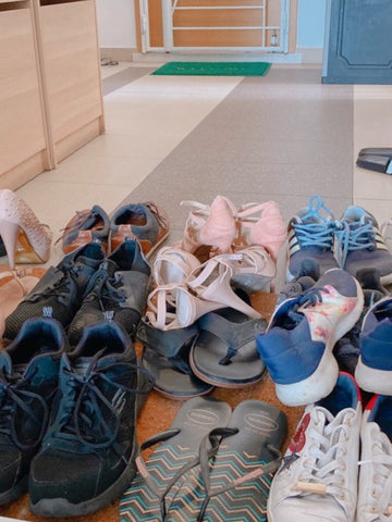 shoes piled up on doormat