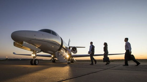Executives getting onto a private jet. 
