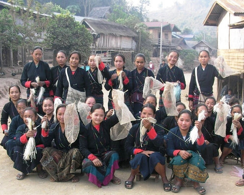 Khmu Artisans in traditional dress displaying Raya Nature Bags made of JungleVine® Fiber